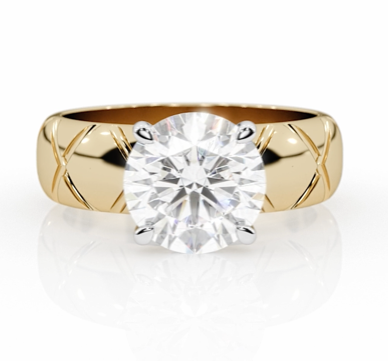 Close-up of a custom engagement ring by lessard coutu jewellery called Bisoux featuring highly detailed yellow gold handcrafted band and a brilliant diamond set in a delicate, handcrafted band.