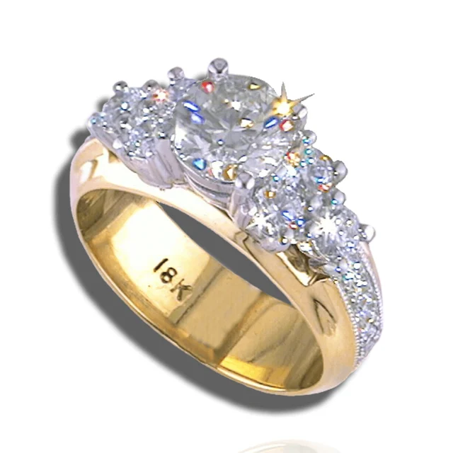 Graduated diamond ring with a large centre stone, pavé shoulders and a wide yellow-gold band.