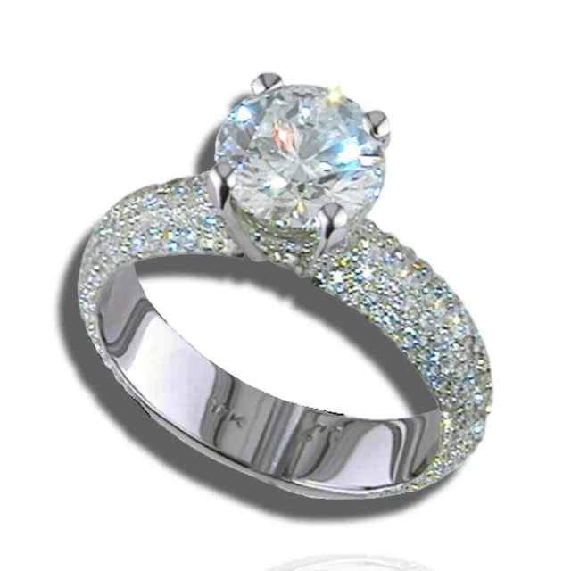 Round solitaire above a broad band covered in pavé diamonds.