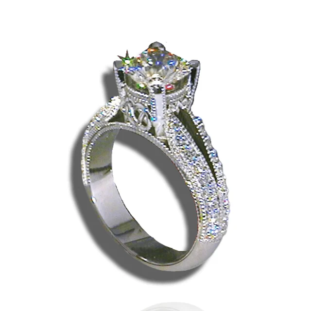 Elevated solitaire ring with a decorative open gallery, split shoulders, pavé diamonds and beaded edges.