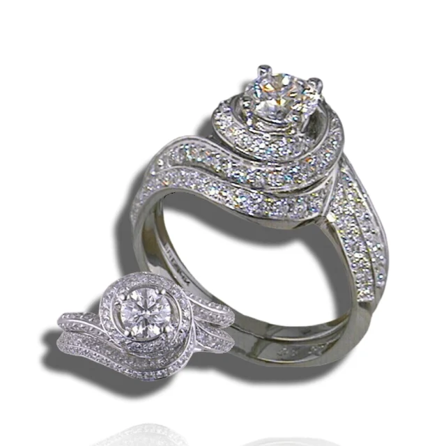 Two views of a round-centred ring with spiralling pavé rows and curved diamond-set shoulders.
