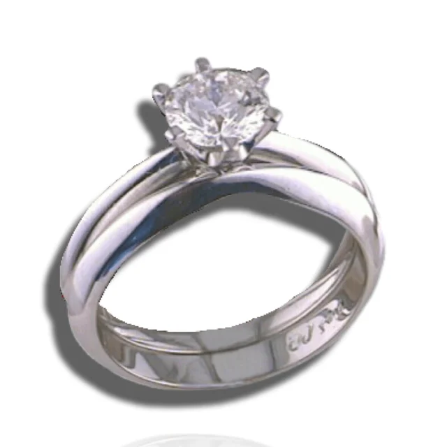 Round solitaire in a six-prong setting above closely fitted, contoured polished bands.