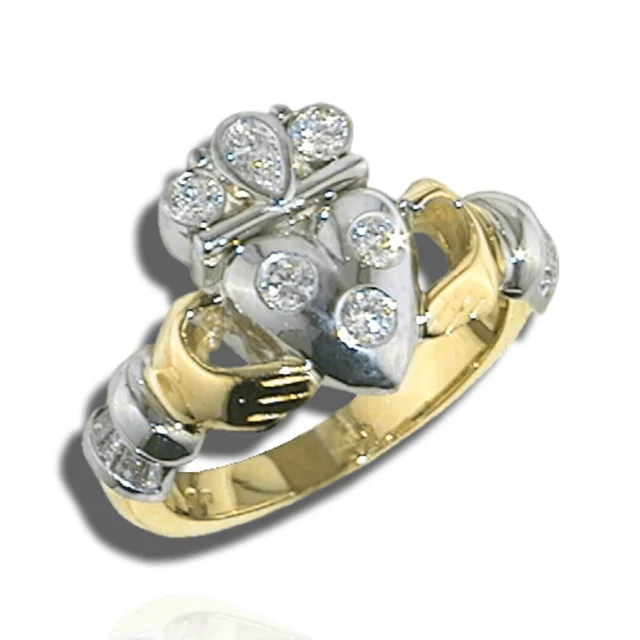 Two-tone Claddagh ring with clasped hands, a diamond-set heart and a crown topped by a pear-shaped stone.