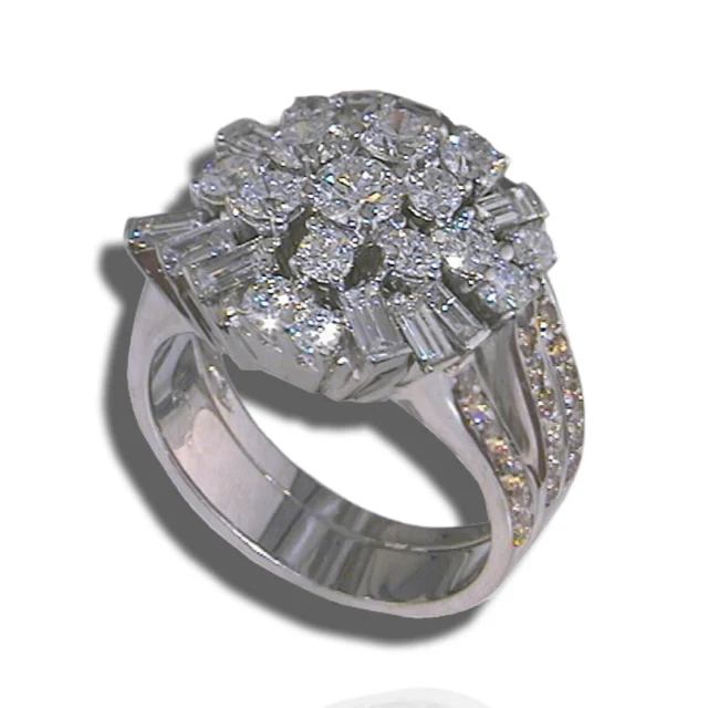 Cluster ring combining round diamonds and radiating baguettes above split, diamond-set shoulders.