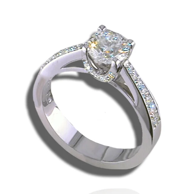 Raised centre stone above open split shoulders, with small diamonds along the shoulders and beneath the setting.