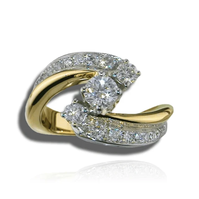 Three round diamonds set diagonally between sweeping two-tone shoulders with polished and pavé surfaces.