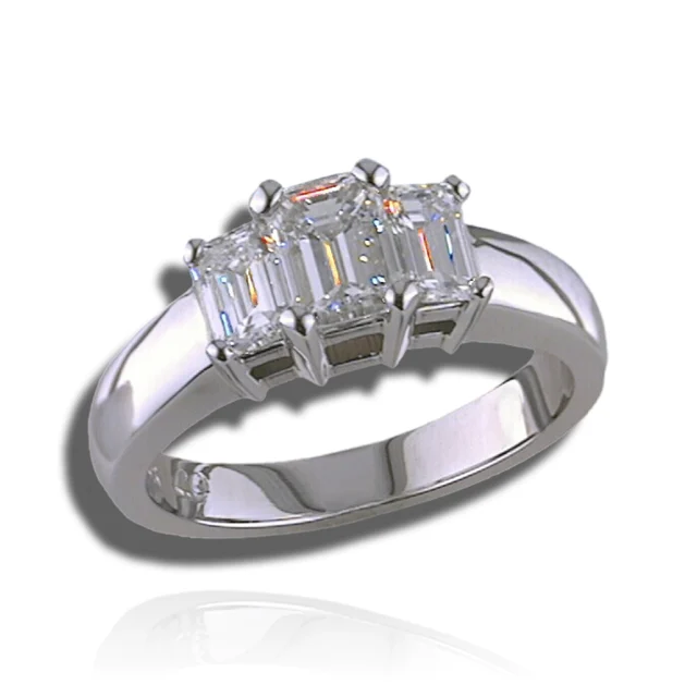 Three emerald-cut stones, with a larger centre and two smaller side stones, on a polished band.