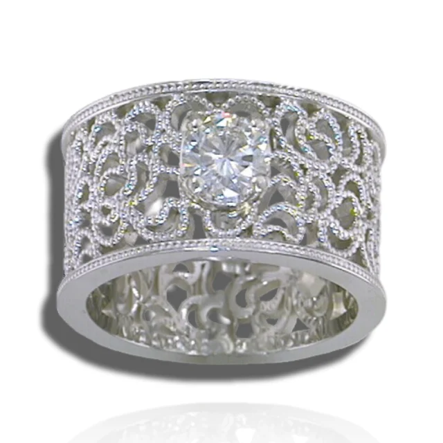 Wide openwork ring with curling filigree, fine beaded borders and a prominent centre stone.