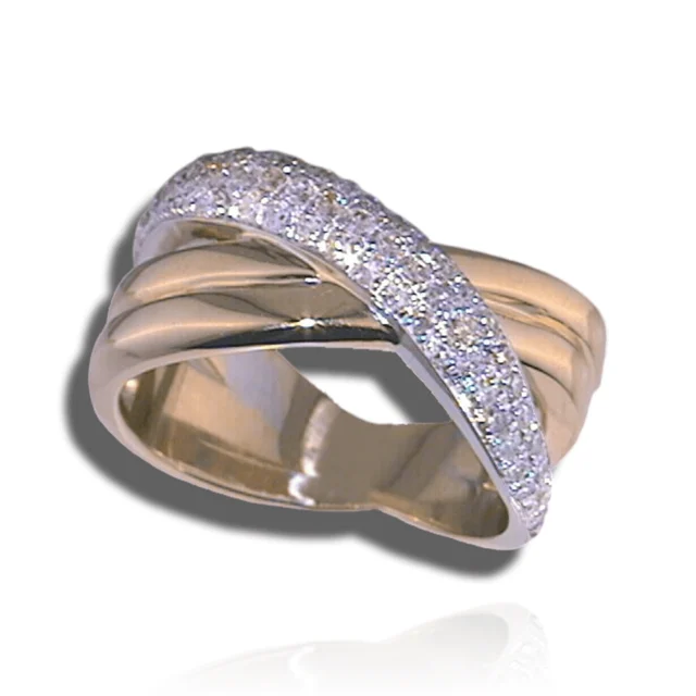 Broad two-tone ring with a diagonal pavé diamond ribbon crossing layered polished curves.