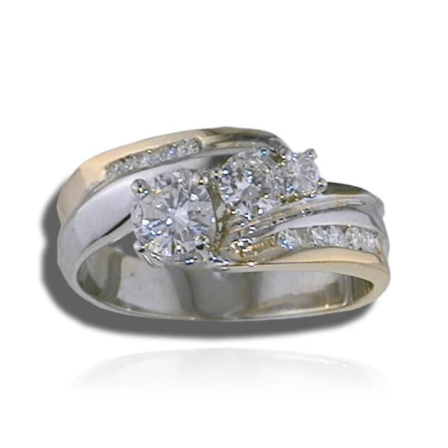 Two-tone ring with three graduated round stones and curved, diamond-set shoulders.