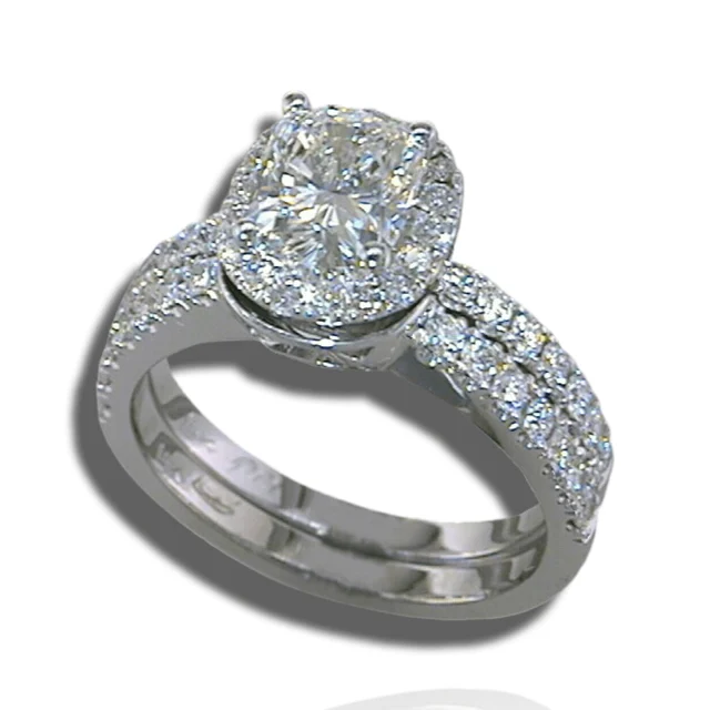 Raised centre stone surrounded by a diamond halo, with diamonds along the ring's shoulders.