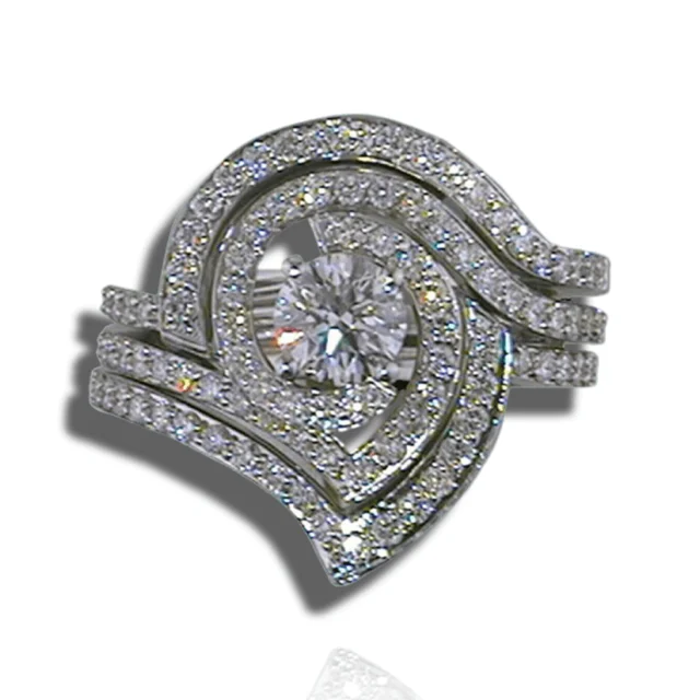 Pear centre stone framed by swirling, layered rows of diamonds encircling the finger.